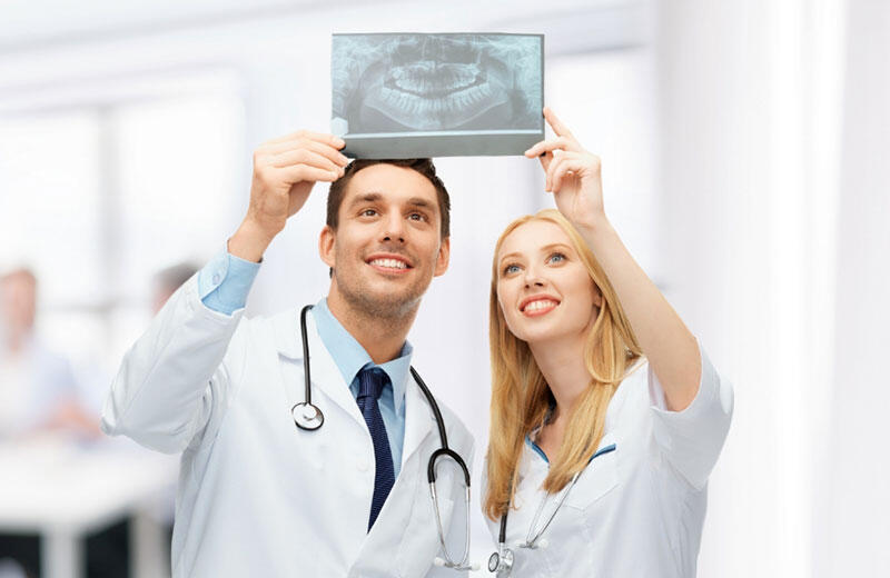 Dentists reviewing a dental X-ray